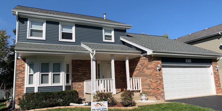 Full exterior remodeling vinyl siding installation shingle roof replacement in Naperville project photo 1