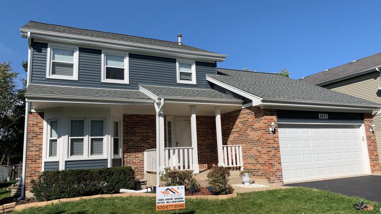 Full exterior remodeling vinyl siding installation shingle roof replacement in Naperville project photo 1