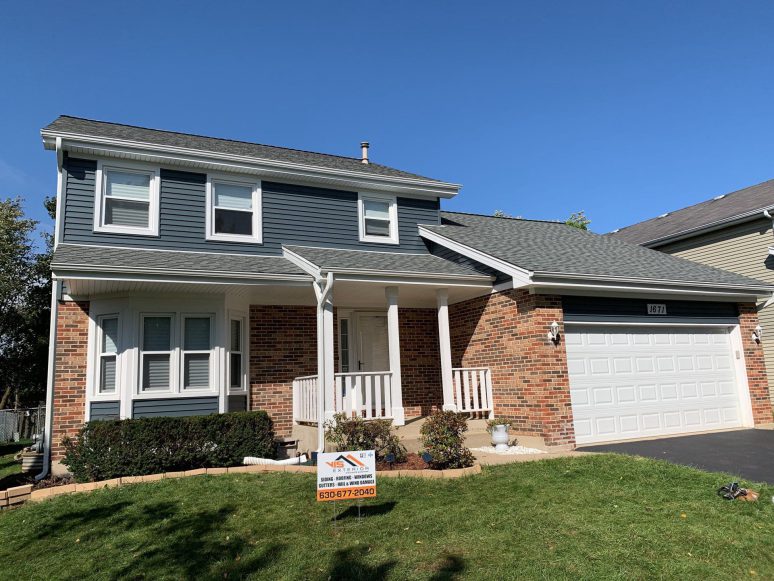 Full exterior remodeling vinyl siding installation shingle roof replacement in Naperville project photo 1