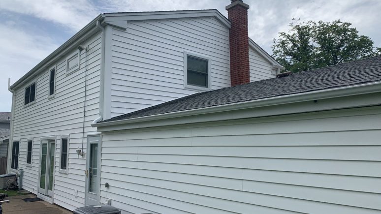 Vinyl siding installation & gutters replacement after hail damage in Downers Grove project photo 1