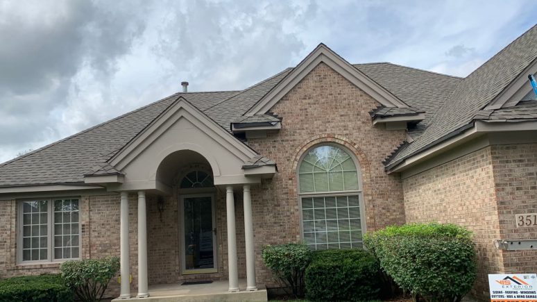 Vinyl siding & shingle roofing after hail damage in Naperville project photo 1