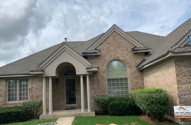 Vinyl siding & shingle roofing after hail damage in Naperville project photo 1