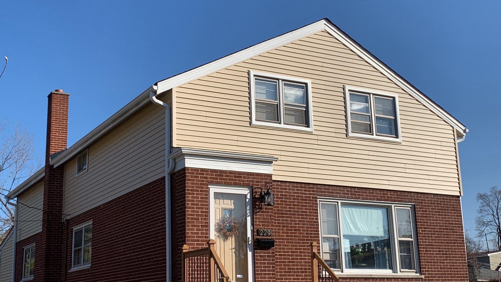 Complete vinyl siding and GAF shingle roof replacement after hail damage in Lombard project photo 1