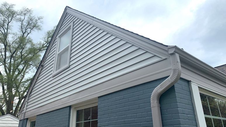 Vinyl siding installation and shingle roof replacement after hail damage in Clarendon Hills project photo 2